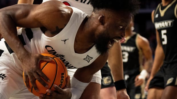 Cincinnati Bearcats forward John Newman III (15) pulls down a rebound in the first half of the NCAA Basketball game between the Bryant Bulldogs and Cincinnati Bearcats at Fifth Third Arena in Cincinnati on Tuesday, Dec. 12, 2023.  